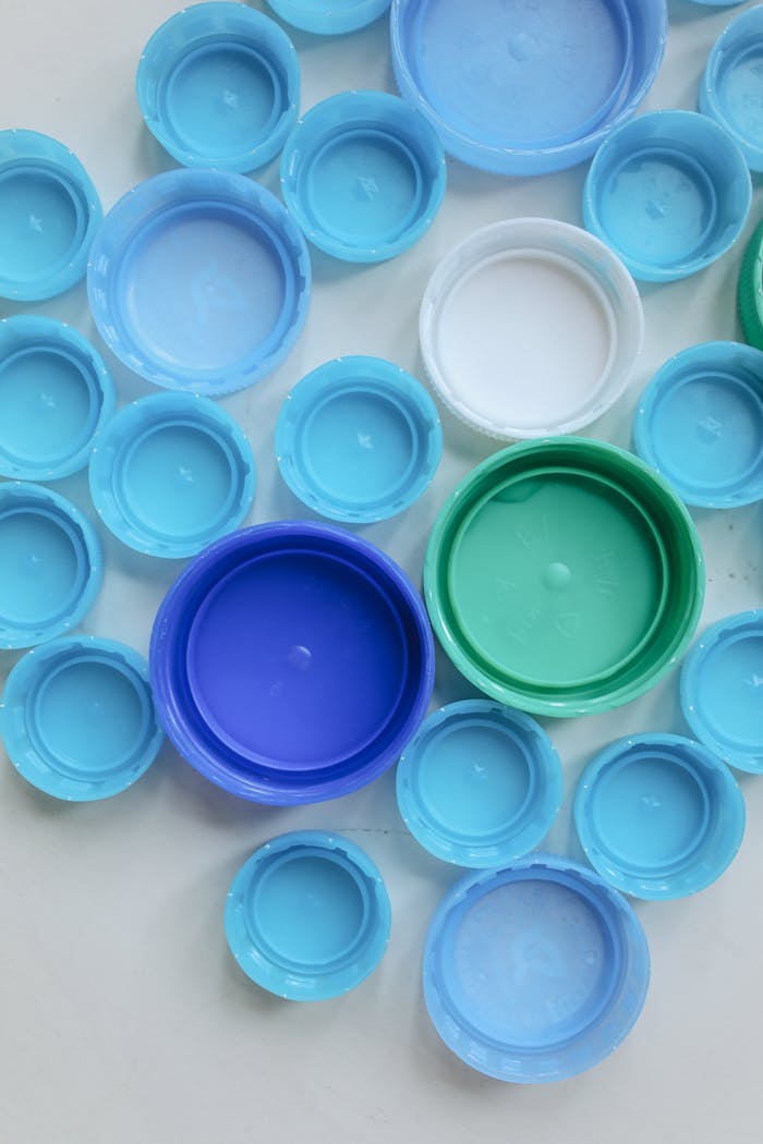 Top view of assorted colorful plastic bottle caps, promoting recycling and sustainability.